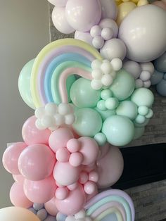 a bunch of balloons that are in front of a fireplace