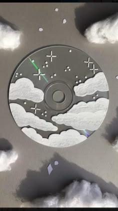 a cd cover with clouds and stars in the sky as if it were made out of paper