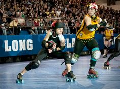 three people on roller skates in front of an audience