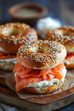 bagel sandwiches with salmon and cream cheese on a wooden plate, ready to be eaten