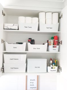 an organized pantry with white bins and labeled labels