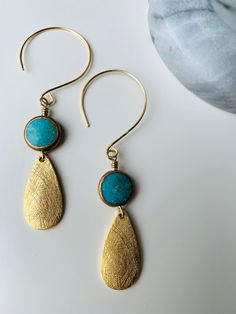 Unique ear wire turquoise earring with brass tear drops finish. Fun and whimsical! Artisan Dangle Teardrop Earrings With Ear Wire, Artisan Teardrop Dangle Earrings With Ear Wire, Nickel Free Brass Dangle Teardrop Earrings, Nickel Free Brass Teardrop Dangle Earrings, Nickel-free Brass Dangle Teardrop Earrings, Bronze Nickel-free Drop Earrings, Handmade Bronze Teardrop Earrings, Bohemian Teardrop Earrings With Lever Back, Bohemian Brass Teardrop Earrings With Ear Wire