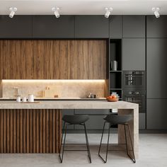 a modern kitchen with two stools next to an island