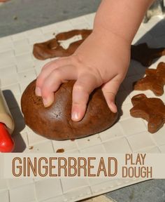 a child's hand on top of a doughnut next to a play doughnut