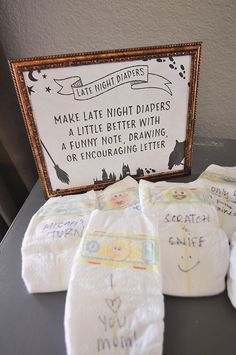 some diapers are sitting on a table next to a sign that says make late night diapers