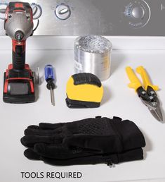 tools are sitting on top of a white counter next to a pair of black gloves