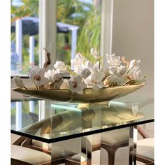 a glass table with white flowers on it