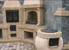 an outdoor pizza oven built into the side of a building with stone walls and flooring