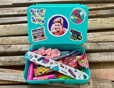 a blue suitcase filled with candy and stickers