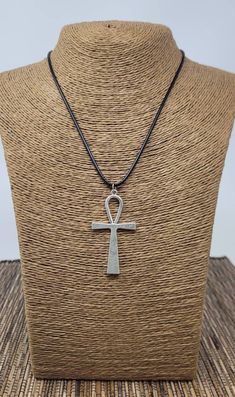 "Ankh Necklace Pendant. Silver-tone Ankh Pendant. Black Cord Necklace. Unisex Design 🔹️🔹️MEANING OF ANKH CROSS🔹️🔹️ 🔹️The ankh symbol sometimes referred to as the key of life or the key of the Nile is representative of eternal life in Ancient Egypt 🔹️It could also have a more physical connotation: the ankh may represent water, air, and the sun, which were meant to provide and preserve life in Ancient Egyptian culture 🔸️🔸️DIMENSIONS🔸️🔸️ 🔸️Ankh Pendant: 2\" Inches Long 🔸️Adjustable Neck Traditional Adjustable Cross Jewelry, Symbolic Ankh Necklace Adjustable, Symbolic Ankh Necklace, Bohemian Ankh Necklace In Metal, Traditional Ankh Necklace For Gifts, Adjustable Silver Ankh Necklace, Ankh Egyptian, Life In Ancient Egypt, Egyptian Cross