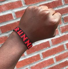 Runner 26.2 Bracelet Black Beads Red letters and numbers One side : Runner Other side : 26.2 Handmade in Ghana This product was designed by nature to fit the wrist. PLEASE use lotion or soap and water to help get the bracelet over your Masai Jewelry, Ghana, Black Beads, Kenya, Handmade Bracelets, Arm Band, Embroidered Friendship Bracelet, Lotion, Jewelry Bracelets