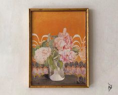 there is a painting on the wall with flowers in it and an orange background behind it