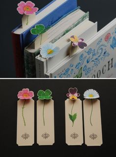 three bookmarks with flowers attached to them, and one has an open book in the middle