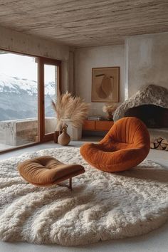 an orange chair sitting on top of a rug in a living room next to a fire place