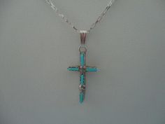 This necklace has a 12.5mm x 23mm sterling silver cross with Zuni turquoise needlepoint stones on an 18" sterling silver elongated box chain with a sterling silver lobster claw clasp. Blue Sterling Silver Cross Pendant Necklace, Southwestern Silver Cross Pendant Necklace, Southwestern Style Silver Cross Pendant Necklace, Turquoise Sterling Silver Cross Necklace, Turquoise Cross Sterling Silver Necklace, Turquoise Cross Necklace In Sterling Silver, Silver Turquoise Cross Necklace For Gift, Southwestern Style Silver Cross Necklaces, Southwestern Style Silver Cross Necklace