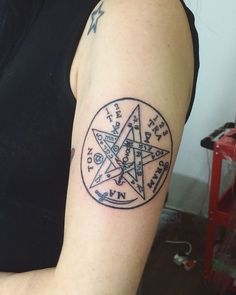 a woman with a tattoo on her arm has a pentagramil in the middle