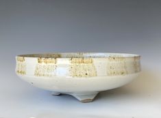 a white and brown bowl sitting on top of a table