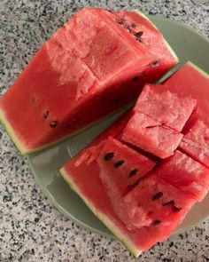 two slices of watermelon on a green plate