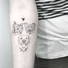 three dogs tattoo on the left upper arm