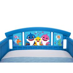 a blue bed with two cartoon characters on the headboard and bottom panel, in front of a white background