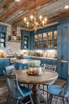 an old fashioned kitchen with blue cabinets and wooden floors, including a round dining table