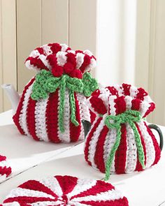 two crocheted candy bags sitting on top of a white table next to each other