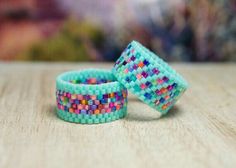 two bracelets sitting on top of a wooden table