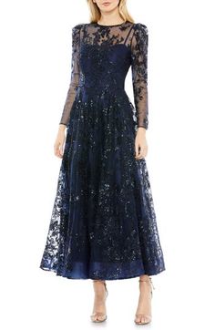 A deeply charming cocktail dress is tumbled in tonal embroidered blooms and cut from frothy, sheer tulle. 48" length Jewel neck Long sleeves Lined 100% polyester Spot clean Imported Asian Owned/Founded Evening Ball Gown With Floral Applique, Floral Applique Ball Gown For Evening, Fitted Ball Gown Evening Dress With Floral Applique, Elegant Ball Gown With Floral Applique, Formal Tulle Gown With Floral Embroidery, Gala Ball Gown With Floral Embroidery, Floral Embroidered Ball Gown For Gala, Evening Dresses With Floral Applique In Organza, Evening Organza Dress With Floral Applique