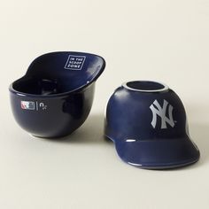 two new york yankees baseball hats next to each other