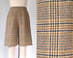 These knee-length wool shorts sport a Prince of Wales plaid pattern in a delightfully late '70s color palette of warm tan, auburn, and goldenrod with dark navy accents. The very high rise and wide leg openings create a funky, offbeat silhouette. Zippered back closure (nylon coil teeth, branded Talon). Fully lined (however, the internal seam allowances are not covered, so you may still prefer to wear a longer undergarment of some sort).  Superb vintage condition. No holes, stains, or other significant damage that we could spot. (The zipper zips completely to the top of the waist; the gap in the photos is because it's a bit tight on the dress form). We repaired a small section of broken seam at the intersection of the rise and inseam (not visible).   No remaining brand or fiber content label Wool Shorts, Navy Accents, Sewing Pants, A Prince, Prince Of Wales, Dress Form, The Gap, Sport Shorts, Vintage 1970s