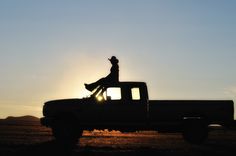 a man riding on the back of a pickup truck