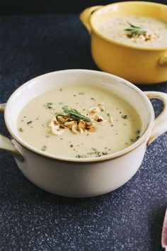 two bowls filled with soup on top of a table