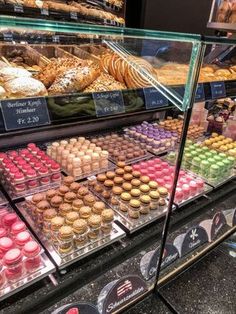 a display case filled with lots of different types of pastries