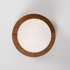 a round wooden object on a white surface