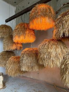 several straw lamps hanging from the ceiling in a room