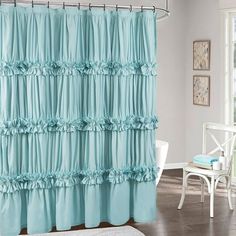 a shower curtain with ruffles on it in a bathroom