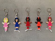 six keychains with different colored beads on them, all in the same shape