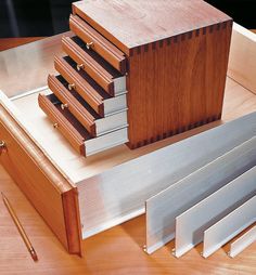 several pieces of wood sitting on top of a wooden table next to a pencil and ruler