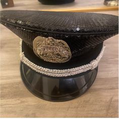 a black hat with a coin on it