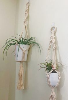 two macrame plant hangers with plants in them hanging on the wall next to each other