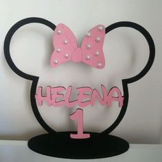 a minnie mouse cake topper with pearls and a bow