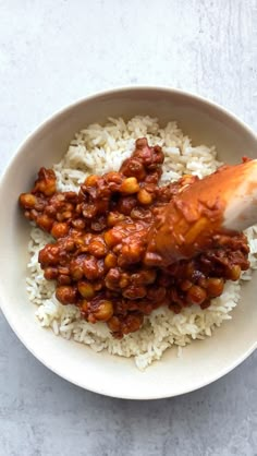 a white bowl filled with rice and beans