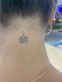 a woman with a small tattoo on her neck