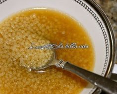 a spoon in a bowl filled with soup