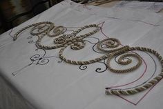 an embroidered tablecloth with decorative designs on it