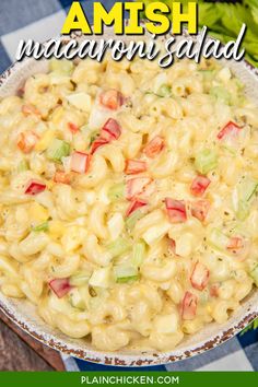 a bowl filled with macaroni salad on top of a checkered table cloth