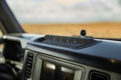 the dashboard of a car with an old fashioned radio