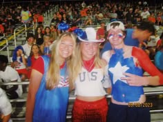 two women and a man in costume at a sporting event