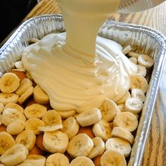 a pan filled with bananas and cream sitting on top of a table