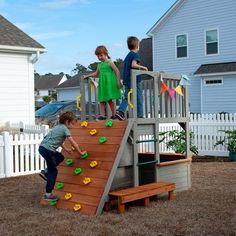 three children are playing on a wooden slide